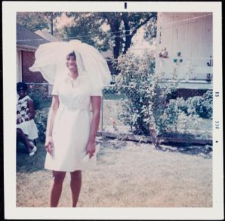 Portrait of a bride with veil and short dress outdoors