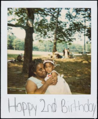 Woman holding little girl in white dress