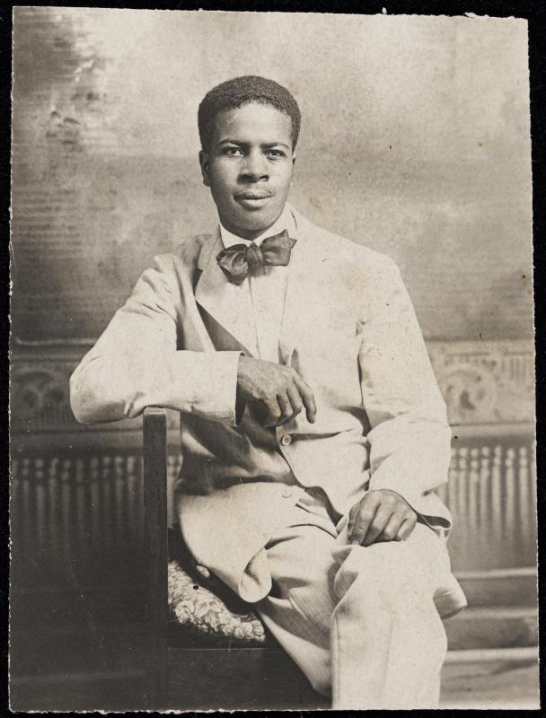 Studio portrait of a seated man with bow tie