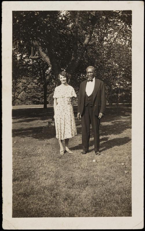 Man and woman posed under apple tree