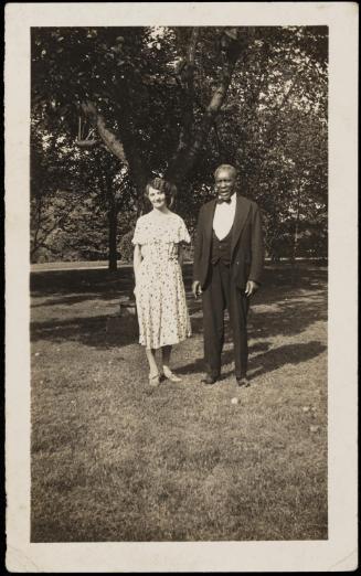 Man and woman posed under apple tree