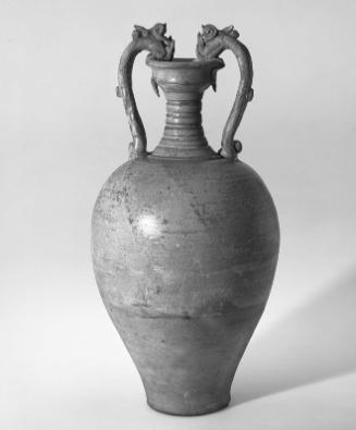 Amphora-shaped bottle with two dragon handles decorated with light green glaze