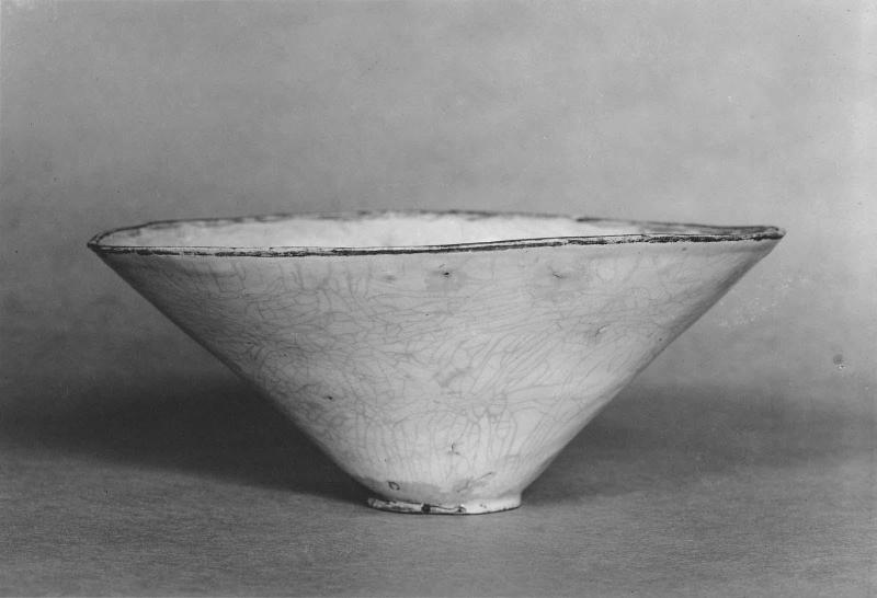 Conical bowl with impressed floral design