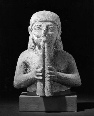 Musician playing double flutes