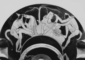 Drinking cup (kylix) depicting a reveler (interior) and satyrs attacking maenads (exterior)