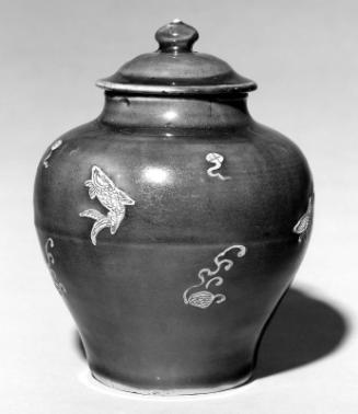 Covered jar with unglazed relief decoration over blue glaze ground