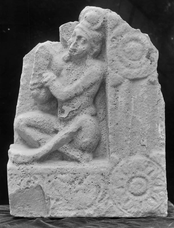 Part of a casing slab: seated figure