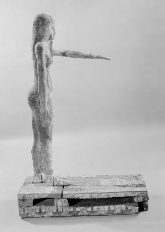 Statue of girl in unusual attitude with hieroglyphic text on base