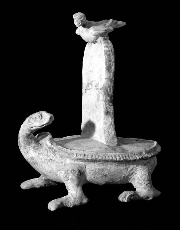 Figure of a tortoise carrying a tablet surmounted by a bird decorated with green glaze