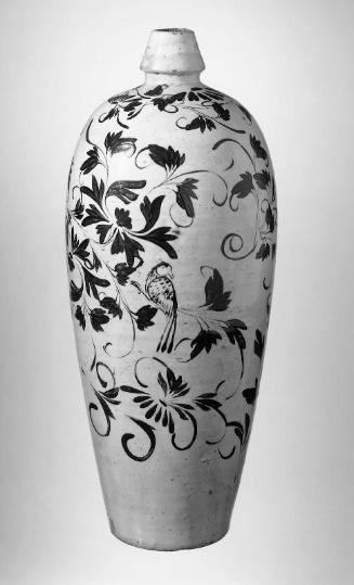 Wine bottle with a bird in flowering vines