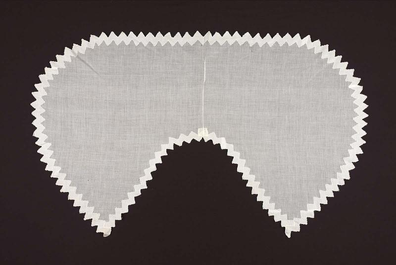 A sheer white cotton cape
