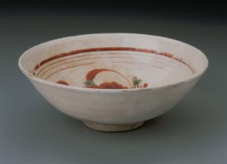 Stoneware tea bowl with overglaze enamel decoration of flower