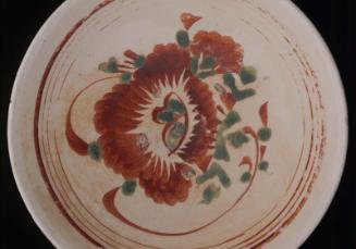 Stoneware tea bowl with overglaze enamel decoration of flower