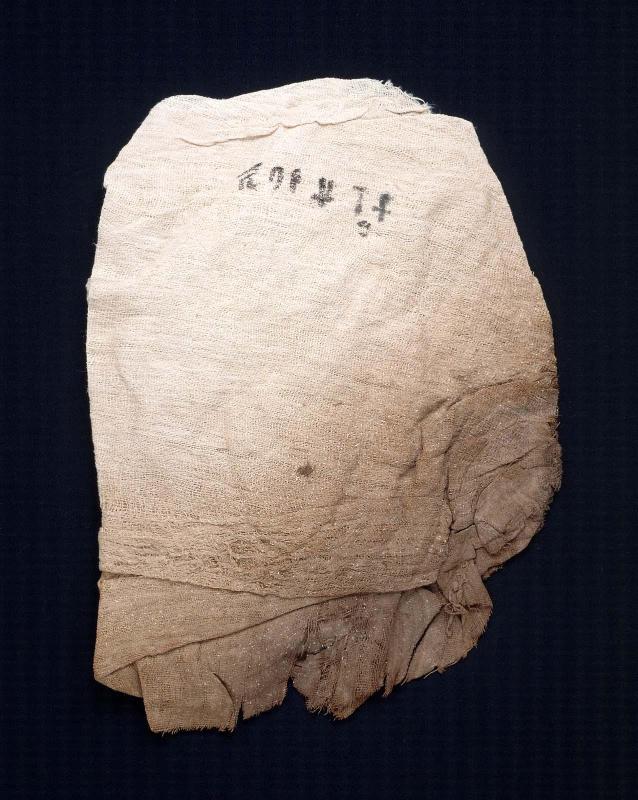 Folded pad of  inscribed linen