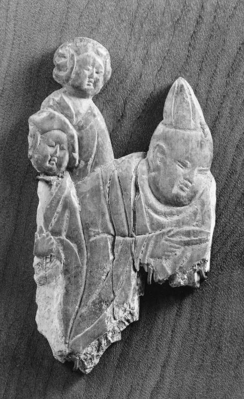Man with a pointed cap and two female attendants