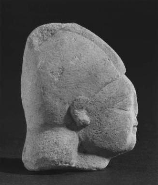Head of a beardless male wearing a conical helmet