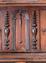 Large applied spindle next to door of lower compartment