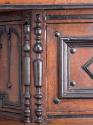 Large applied spindle next to door of upper compartment