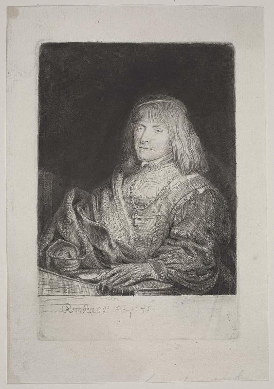Man at a Desk Wearing a Cross and Chain