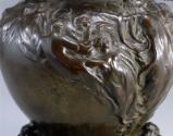 Figures emanating from right of central figure on Side B
