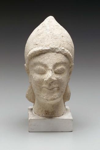 Beardless male votary wearing conical helmet