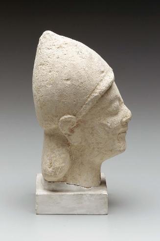 Beardless male votary wearing conical helmet