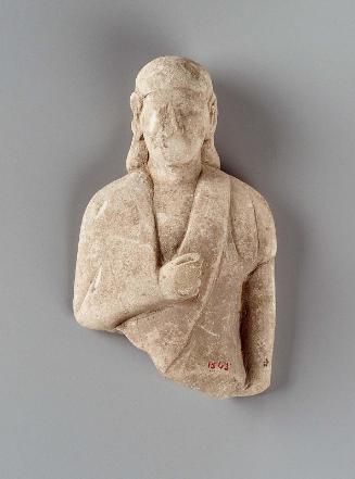Beardless male votive figure wearing long garment and headcloth