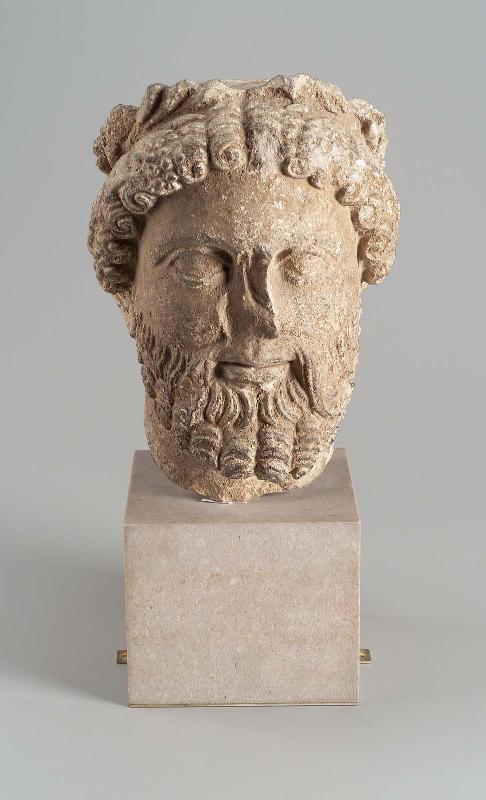 Bearded head with wreath of leaves