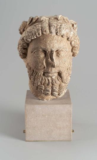 Bearded head with wreath of leaves