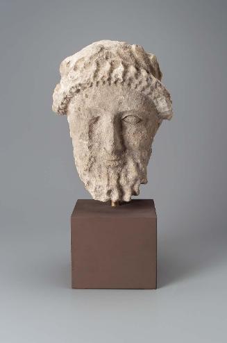 Bearded head with wreath of leaves and flower buds