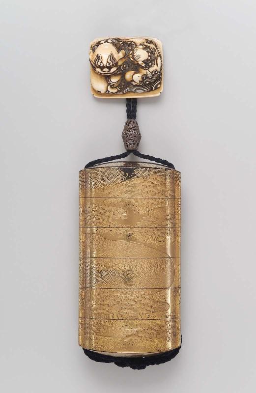 Netsuke in the form of a shishi and young with mokugyo