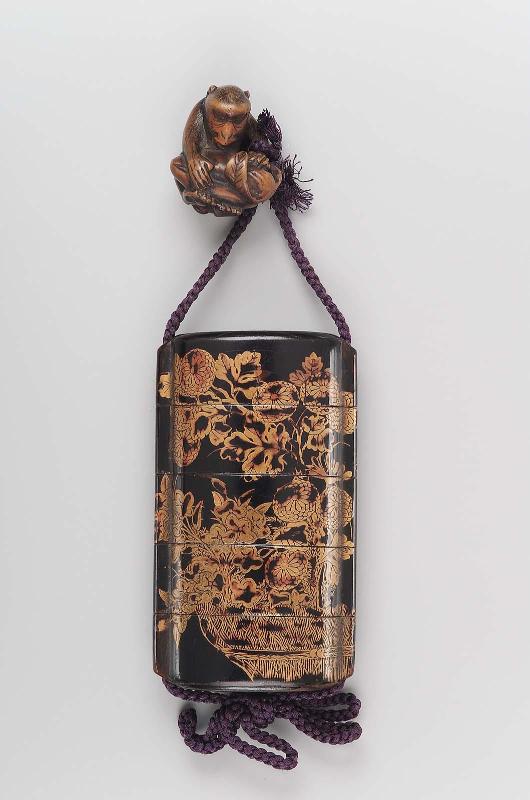 Netsuke in the form of a monkey with a large fruit