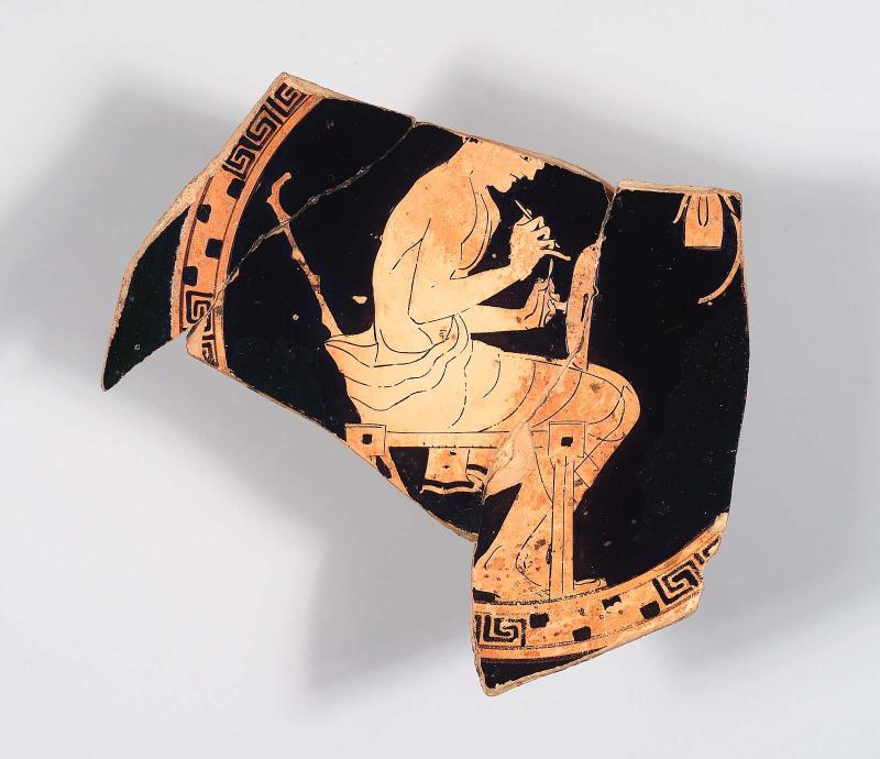 Fragment of drinking cup (kylix) with man decorating a kylix