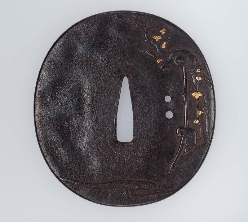 Tsuba with design of monkeys reaching down to a stream
