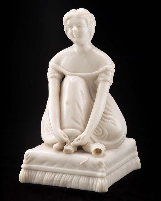 Girl Seated on Cushion Tying Shoe