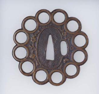 Tsuba formed as twelve rings around a central plate, with design of flowering cherry branches