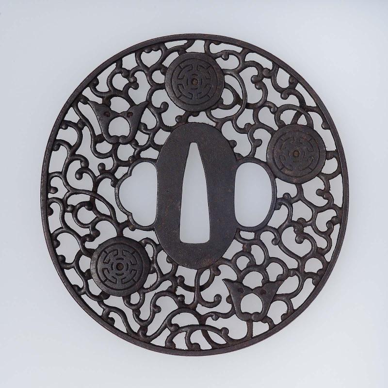 Tsuba with design of daki-myoga, roundels and arabesques