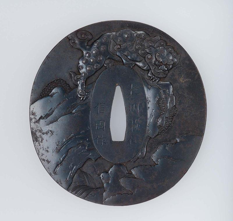 Tsuba with design of shishi on a rock