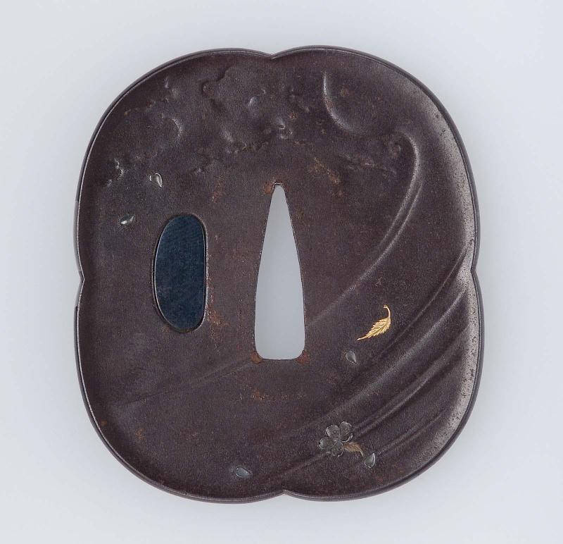 Tsuba with design of leaves and blossom on a wave