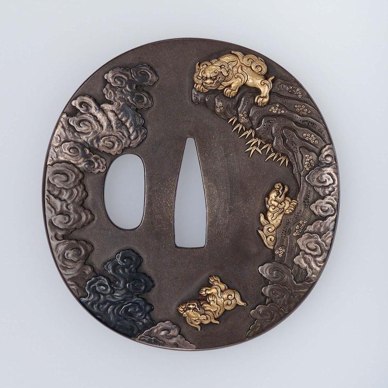 Tsuba with design of mother shishi testing the endurance of her cubs