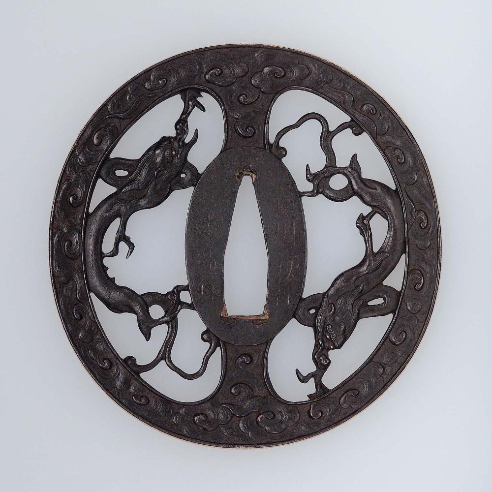 Tsuba with design of confronted rain dragons within a ring of clouds