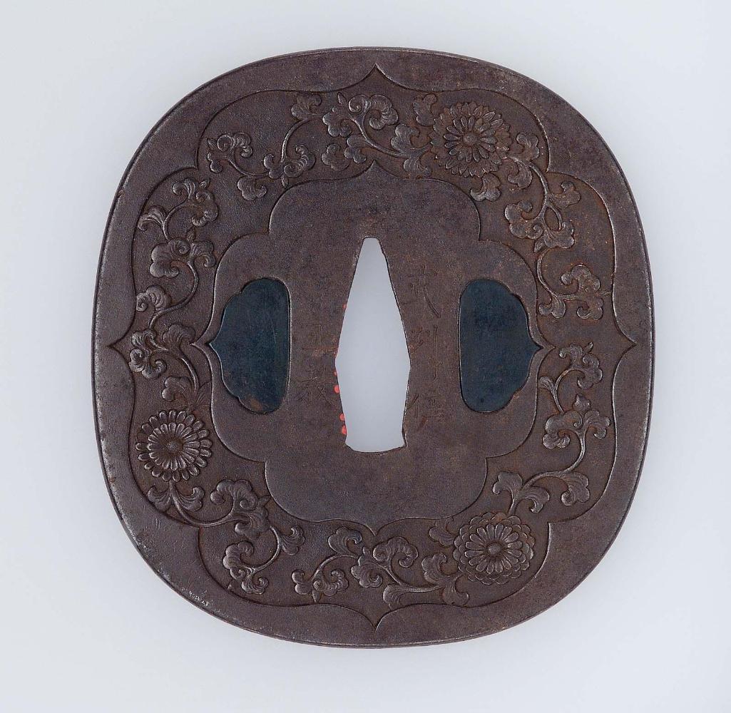 Tsuba with design of chrysanthemum and foliage within ogival reserve