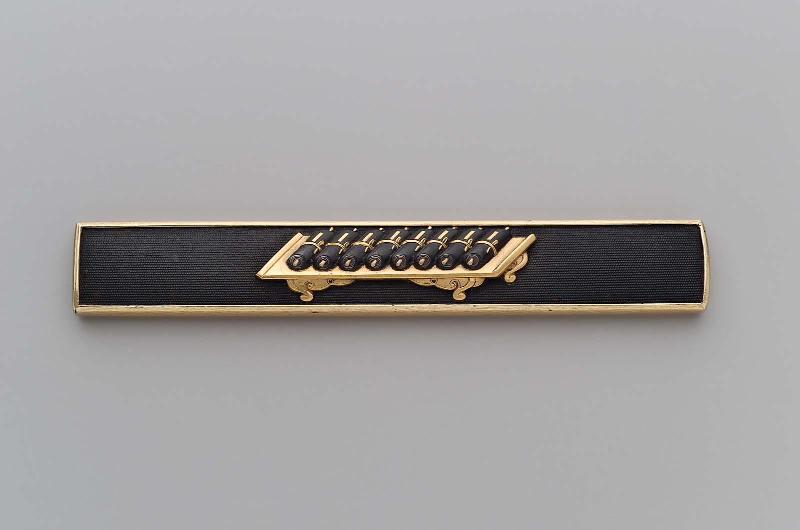 Kozuka with design of scrolls on a table