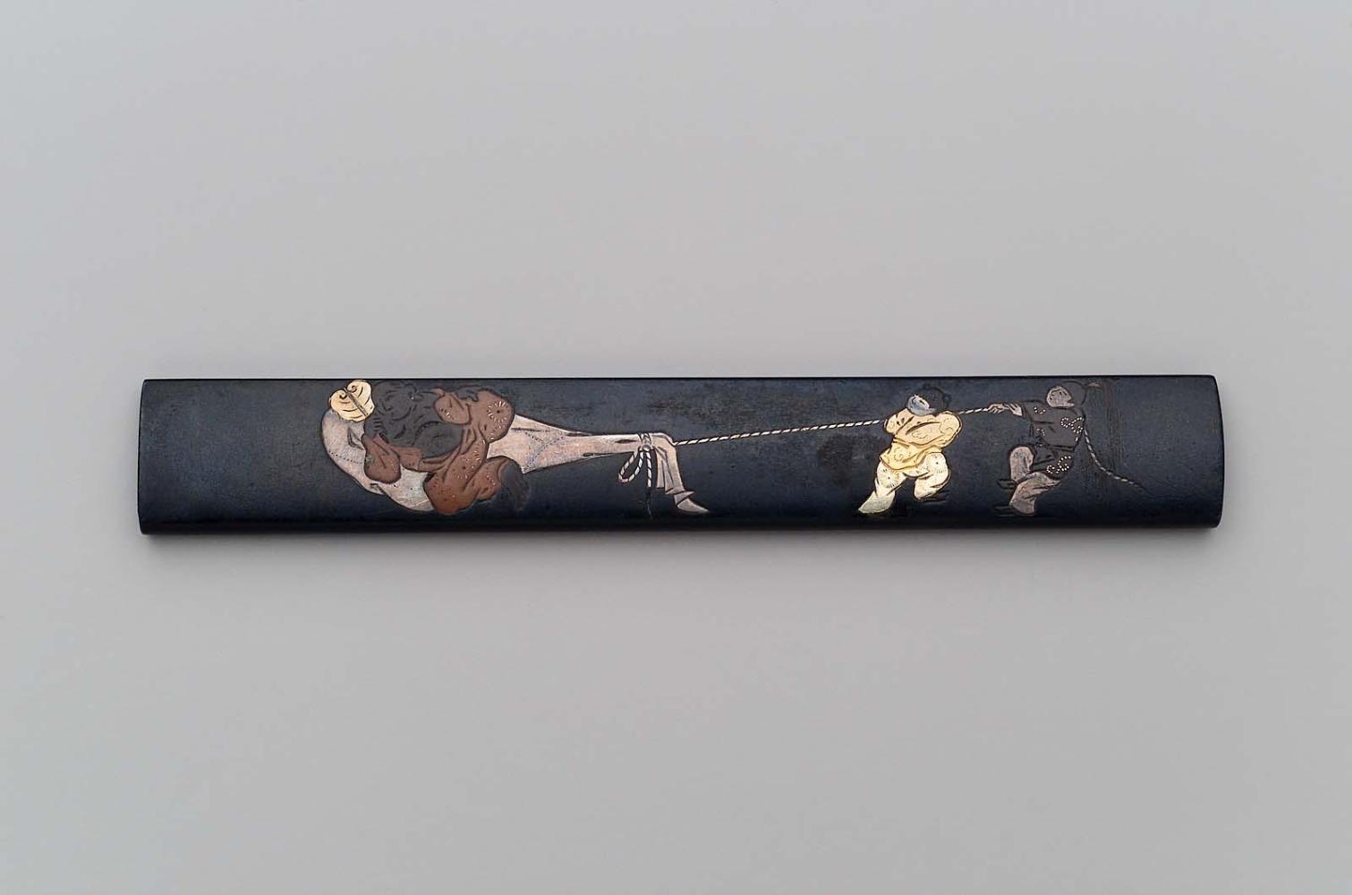 Kozuka with design of Hotei and two Chinese boys pulling his sack