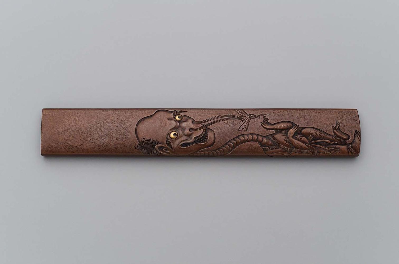 Kozuka with design of Rokurokubi exhaling a dragonfly