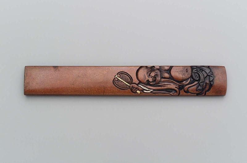 Kozuka with design of Hotei and a boy with a windmill toy