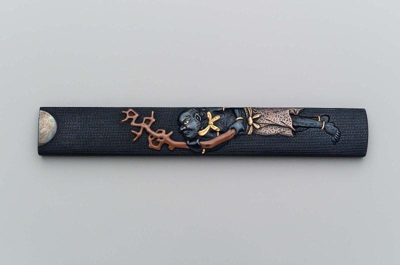 Kozuka with design of Koronbo holding a branch of coral
