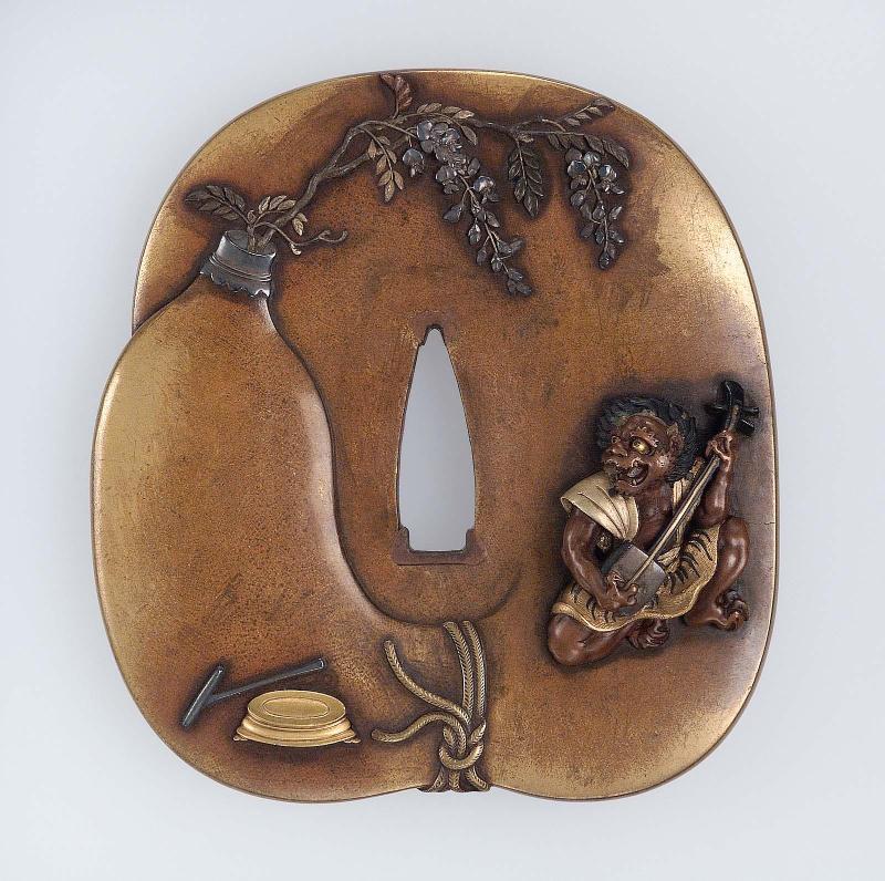 Tsuba with design of oni playing a shamisen on a giant gourd