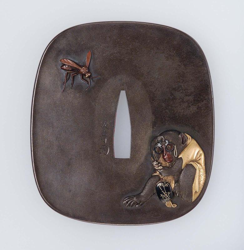 Tsuba with design of a bespectacled monkey studying a netsuke of a monkey