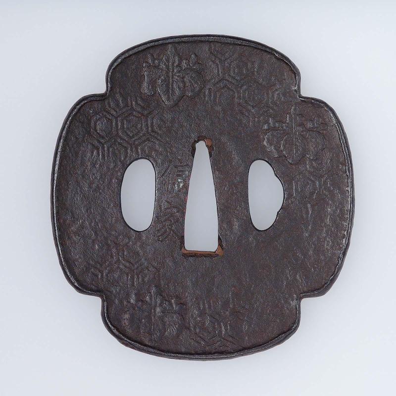 Tsuba with design of paulownia crests on a kikko-mon ground